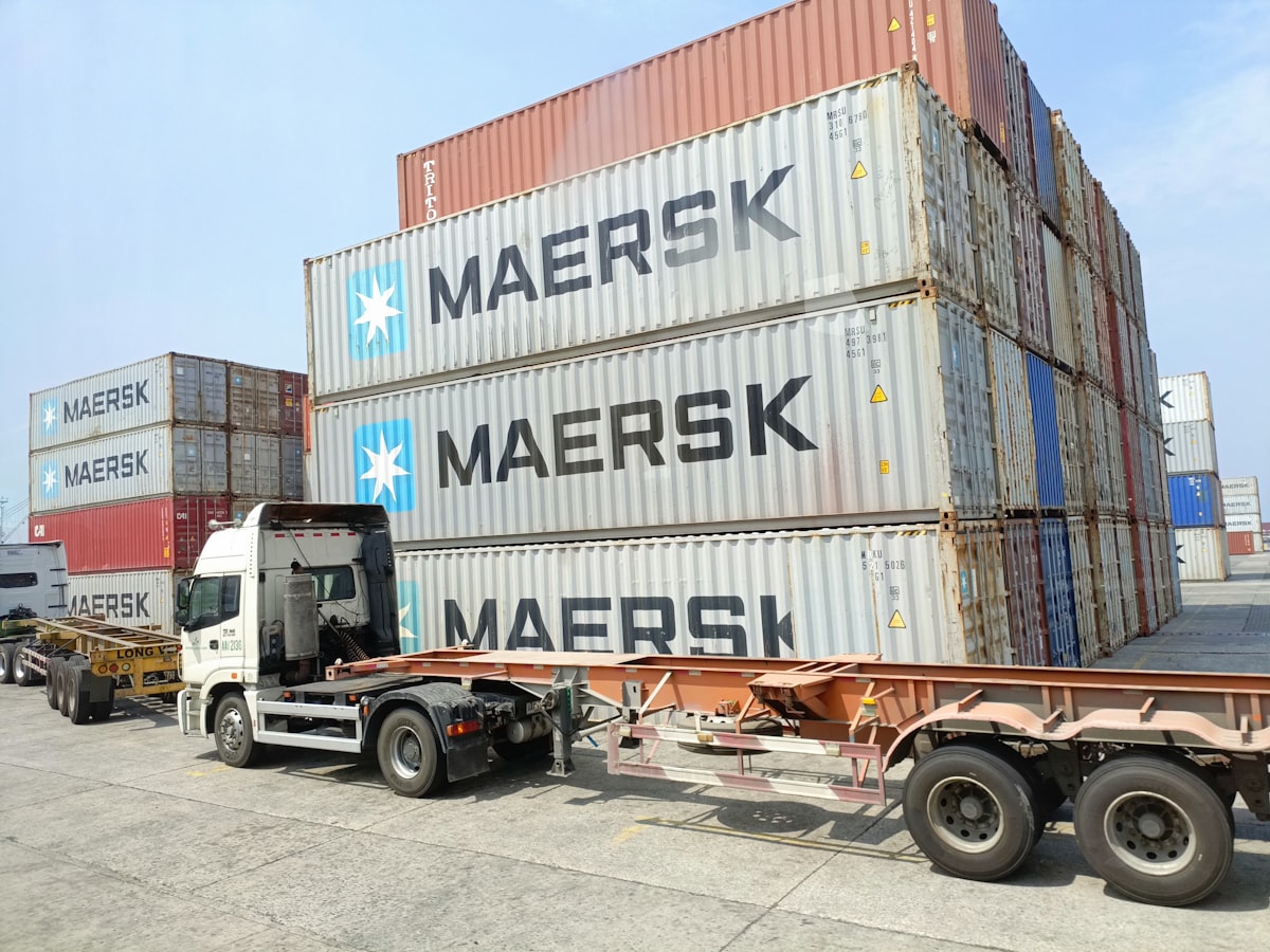 Shipping containers and a truck at the export loading dock