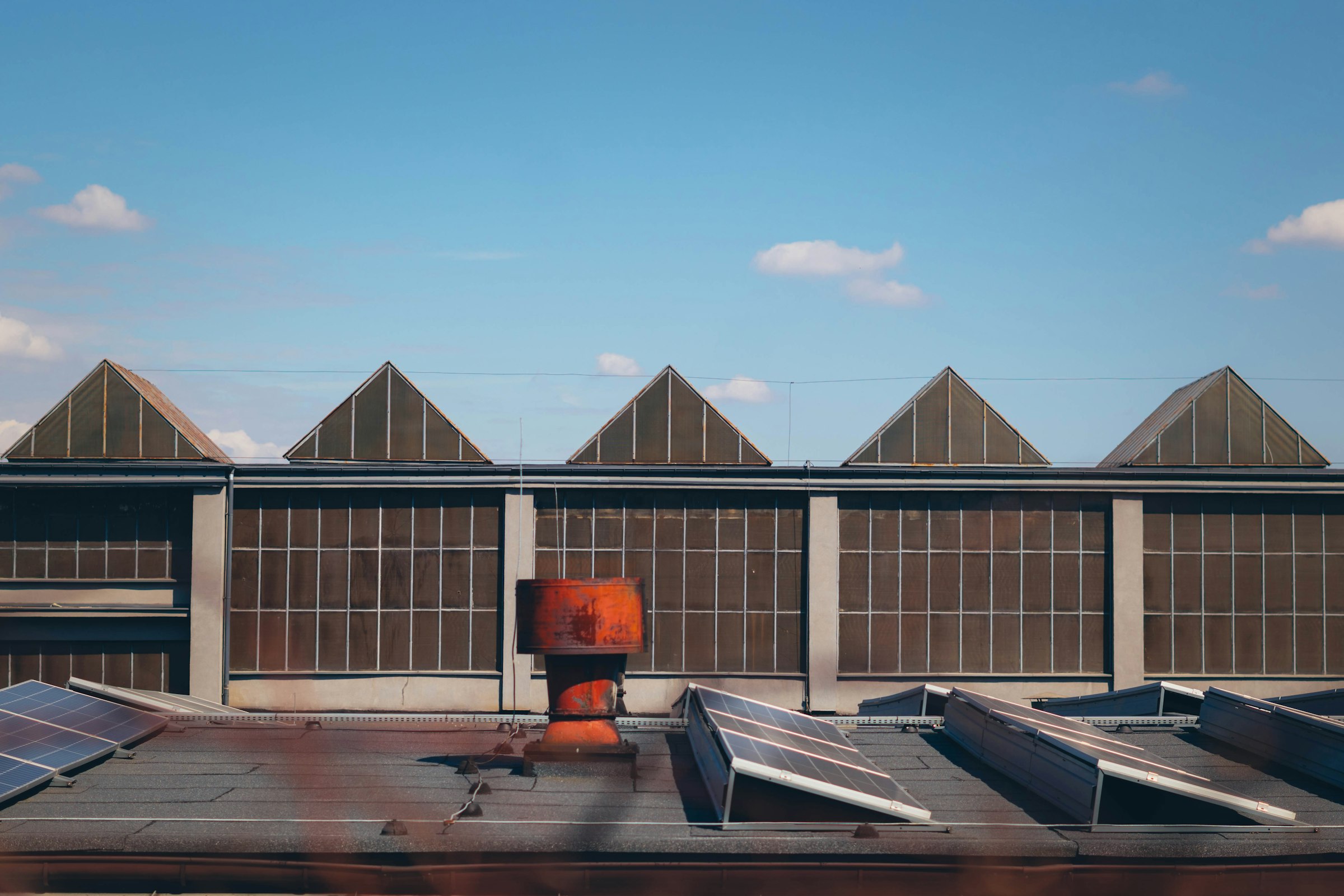 Company manufacturing facility exterior under a clear sky