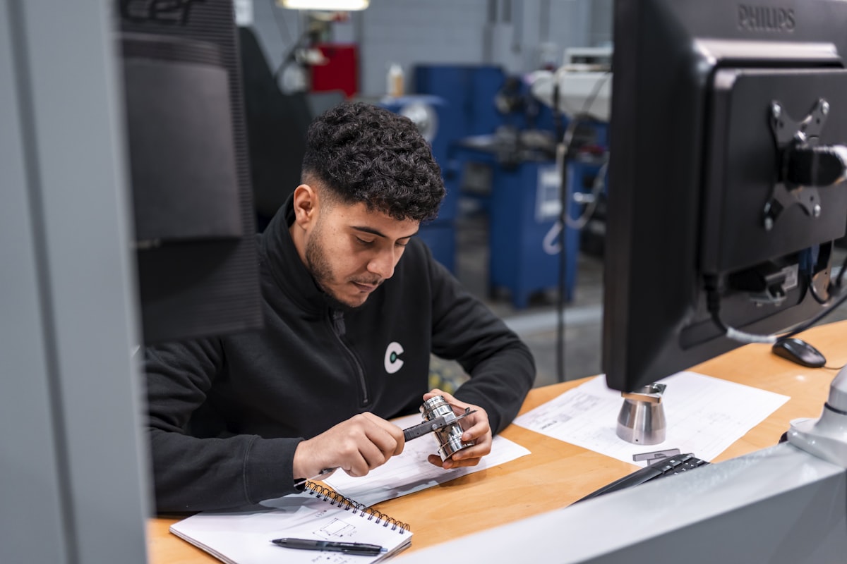 Quality inspector measuring a part with digital calipers